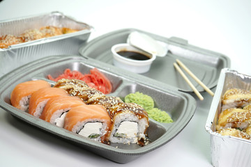 Sushi rolls are Packed in plastic packaging close-up on an isolated background.
