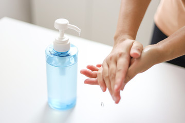 Obraz na płótnie Canvas Hand applying Alcohol gel sanitazer liquid cleaning hands for prevent corona virus covid-19.