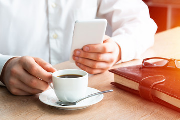 Man in white shirt using smartphone
