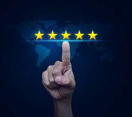 Hand pressing five gold stars to increase rating over digital world map technology style, Business...