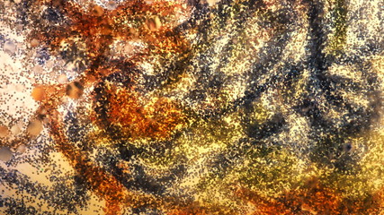 Mixing water and oil, beautiful colors. Close-up. Abstract background of filaments of different colors. Water and oil bubbles. Abstract yellow light illumination