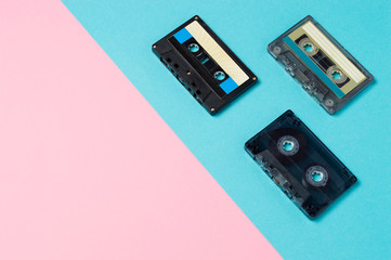 Retro audio cassette tapes on colorful background. Vintage music technology concept.