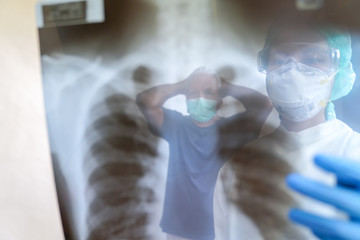Fototapeta premium The doctor examined the chest X-ray film of the patient who came to check the coronavirus epidemic. covid-19 at the hospital