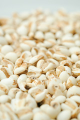 millet in a wooden bowl isolated on white