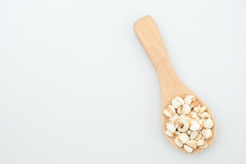 millet in a wooden bowl isolated on white