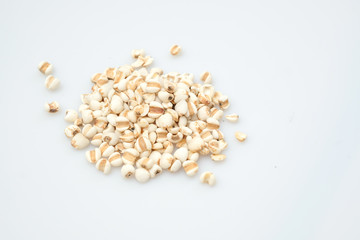 millet in a wooden bowl isolated on white