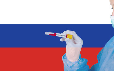 Coronavirus or Covid-19 in Russia, sample blood tube in nurse hand with Russian flag on background. Coronavirus Chinese infection.
