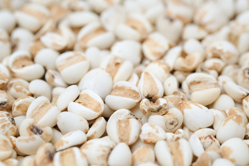 millet in a wooden bowl isolated on white