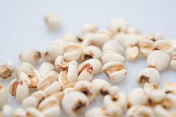 millet in a wooden bowl isolated on white
