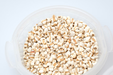 millet in a wooden bowl isolated on white