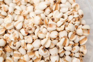millet in a wooden bowl isolated on white