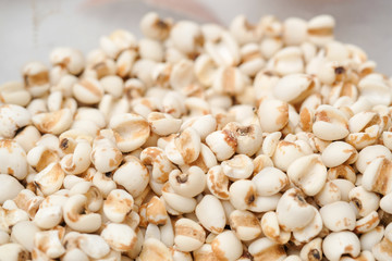 millet in a wooden bowl isolated on white