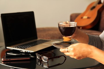 Fototapeta na wymiar COVID-19 or corona virus pandemic work from home concept self-isolation woman hands take a coffee break working from her home. photo 