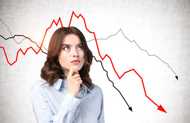 Pensive young businesswoman, falling graph