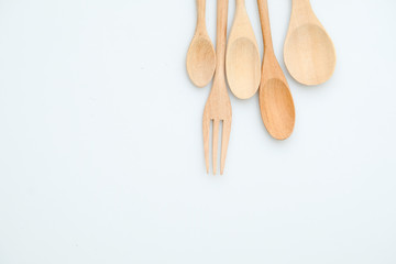 wooden spoon and fork on pastel color background