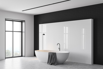 White and black bathroom corner with tub