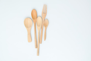 wooden spoon and fork on pastel color background