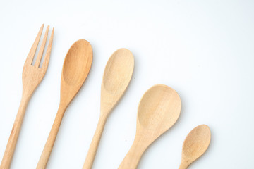 wooden spoon and fork on pastel color background