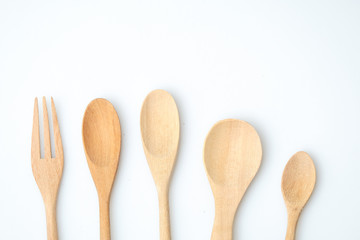 wooden spoon and fork on pastel color background