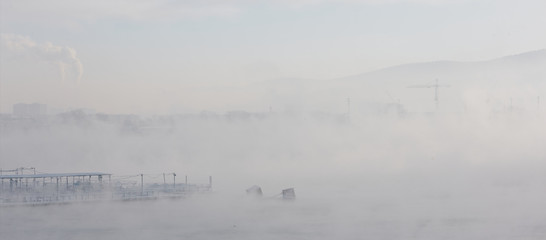 Winter view of the river in the fog