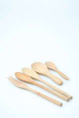 wooden spoon and fork on pastel color background