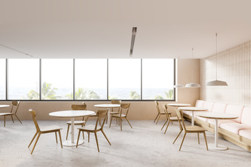 Sofa and round tables in panoramic restaurant