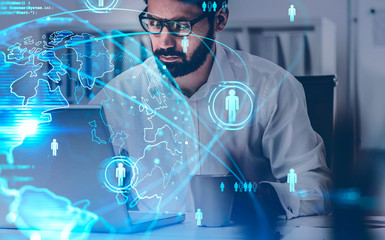 Businessman with laptop in office, social network