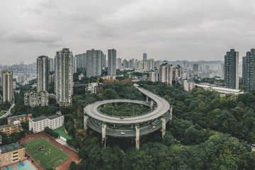 Aerial drone shot of particular double circle flyover road in densed residential buildings in...