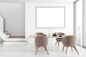 White dining room with poster and stairs