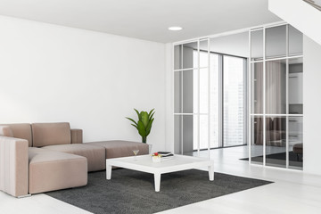 White living room corner with beige sofa