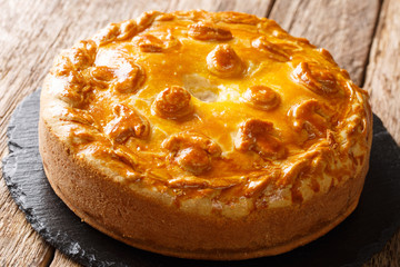 Homemade Russian pie Kurnik with chicken, potatoes and onions close-up on a slate board. horizontal © FomaA