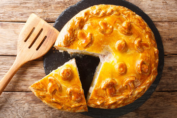 Traditional Russian sliced pie Kurnik close up on a slate board. horizontal top view © FomaA