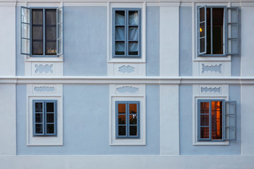 Windows on apartment building with blue facade