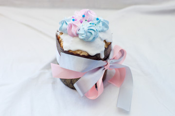 Traditional orthodox easter cake kulich with festive blue and pink decoration. White background, lot of copy space.