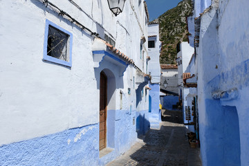 Fototapeta na wymiar Old blue painted street in city of Chefchaouen,Morocco.
