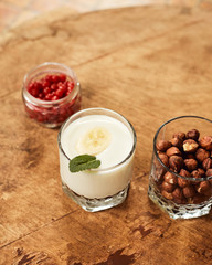 Yogurt with nuts on a wooden light background. Natural yogurt.