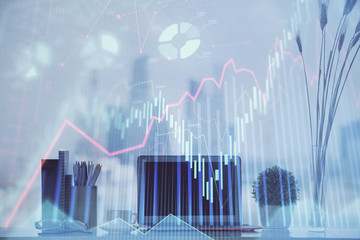 Naklejka premium Forex Chart hologram on table with computer background. Multi exposure. Concept of financial markets.
