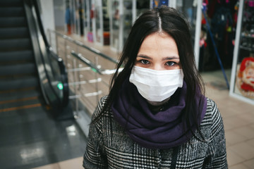 Concept of the coronovirus COVID-19 epidemic . White Caucasian woman wearing a protective medical...