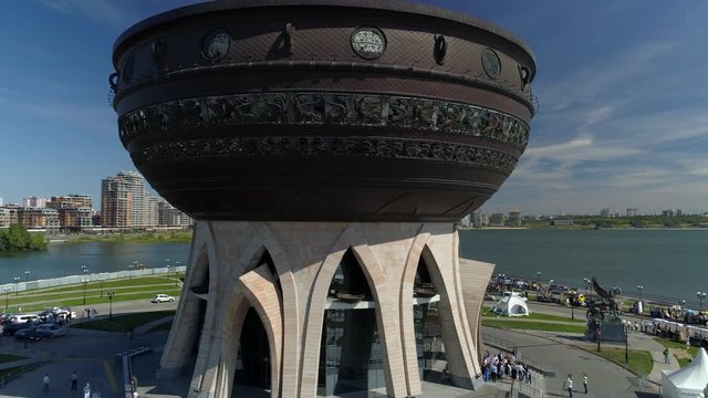 Aerial around cauldron facade Kazan Russia best. Authentic national modern wedding palace ceremony. Sunny day scenic cityscape center embankment Travel attraction. People walk. 
