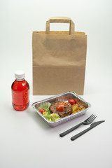 Paper bag foil containers and mors on an isolated background. Contactless food delivery during the quarantine period. © Ekaterina_1525