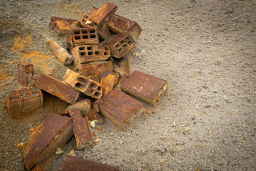 Crashed rusty building bricks on the ground