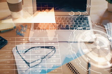 Financial graph colorful drawing and table with computer on background. Double exposure. Concept of international markets.