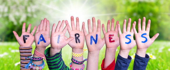 Children Hands Building Colorful Word Fairness. Sunny Green Grass Meadow As Background