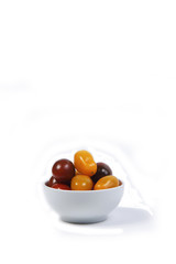 a bowl of Cherry-tomatoes isolated on white background. Vertical image