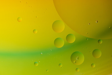Bright abstract green and yellow background with flying bubbles