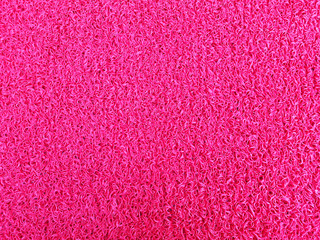 Red, rubber coating on the floor or ground. Background.