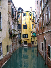 Fototapeta na wymiar Italy, canal in Venice with old houses sweat in the rain