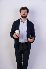 business man in a suit, confident, slim, beard, black hair, s and coffee and smartphone on white background