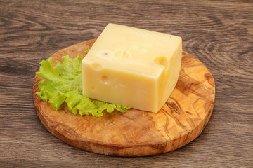 Emmental cheese over wooden board