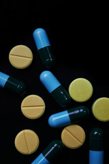 Pill and drug on black background